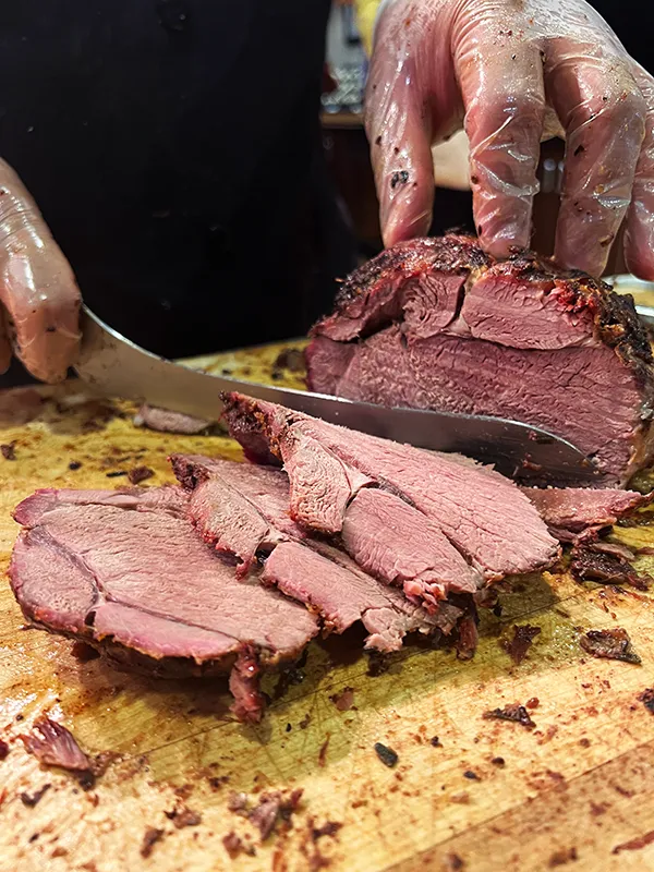 Lamb being carved on a wooden board